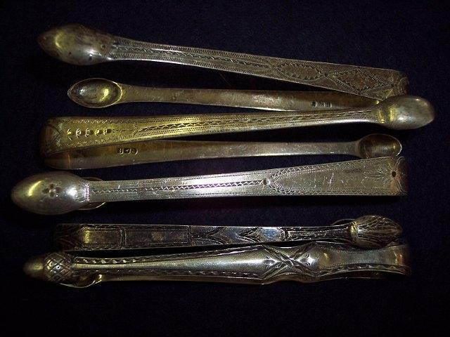 Appraisal: A pair of Georgian bright cut sugar tongs with acorn