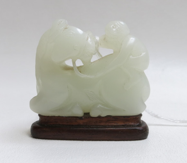 Appraisal: CHINESE CARVED WHITE JADE FIGURE of a monkey on horseback