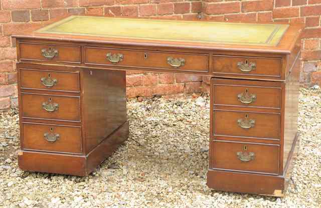 Appraisal: A MAHOGANY PEDESTAL DESK with green leather inset top wide