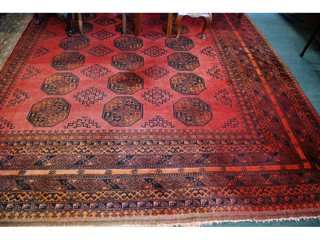 Appraisal: TURKOMAN AFGHAN TRIBAL CARPET with black stencilled design on a