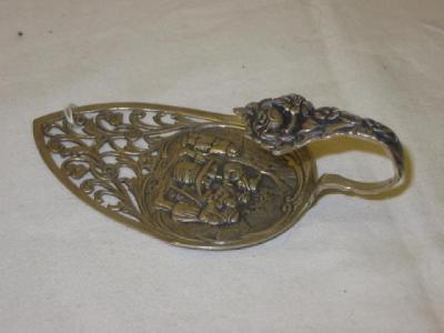 Appraisal: A DUTCH CAKE SERVER the blade pierced with flowers and