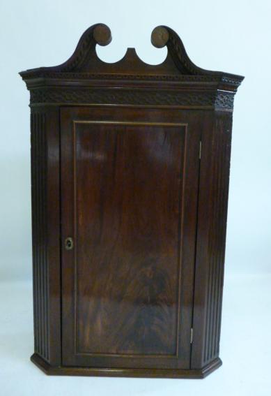 Appraisal: A GEORGE III MAHOGANY CORNER CUPBOARD th century the key