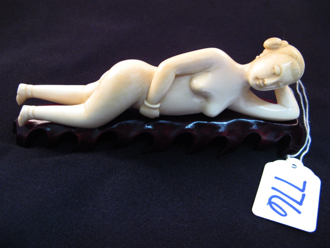 Appraisal: AN IVORY CARVED FIGURE OF A RECLINING WOMAN a medical