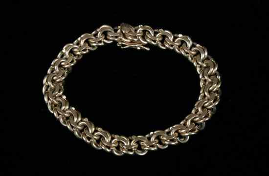 Appraisal: K YELLOW GOLD FLEXIBLE CHAIN LINK BRACELET Flattened curb-links tongue-and-groove