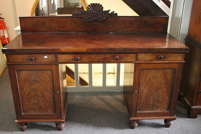 Appraisal: A VICTORIAN MAHOGANY TWIN PEDESTAL SIDEBOARD having a raised shell