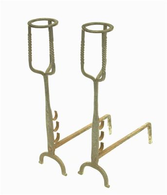 Appraisal: A pair of wrought iron andirons with 'candle holder tops'