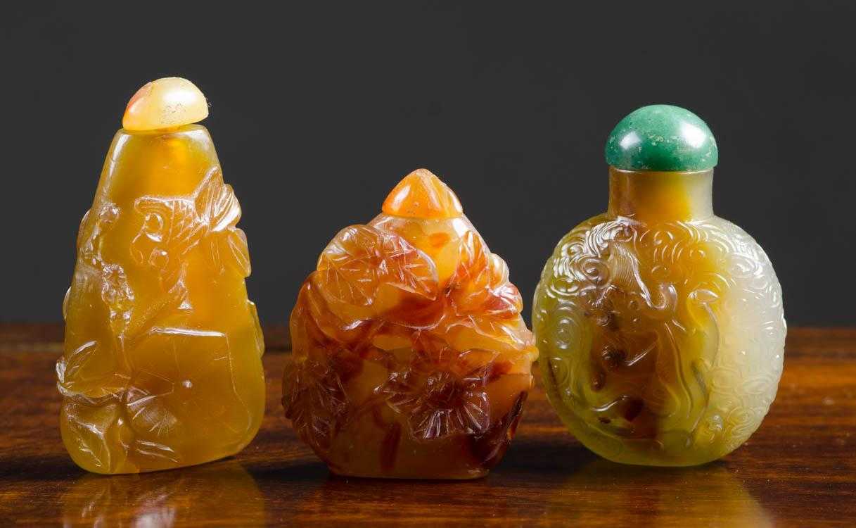 Appraisal: THREE CHINESE CARVED STONE SNUFF BOTTLES in various shapes and