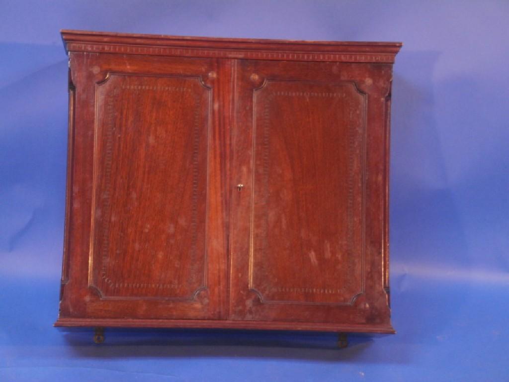 Appraisal: An early thC mahogany wall cabinet enclosed by two panelled