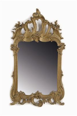 Appraisal: A continental carved giltwood wall mirror the shaped rectangular plate