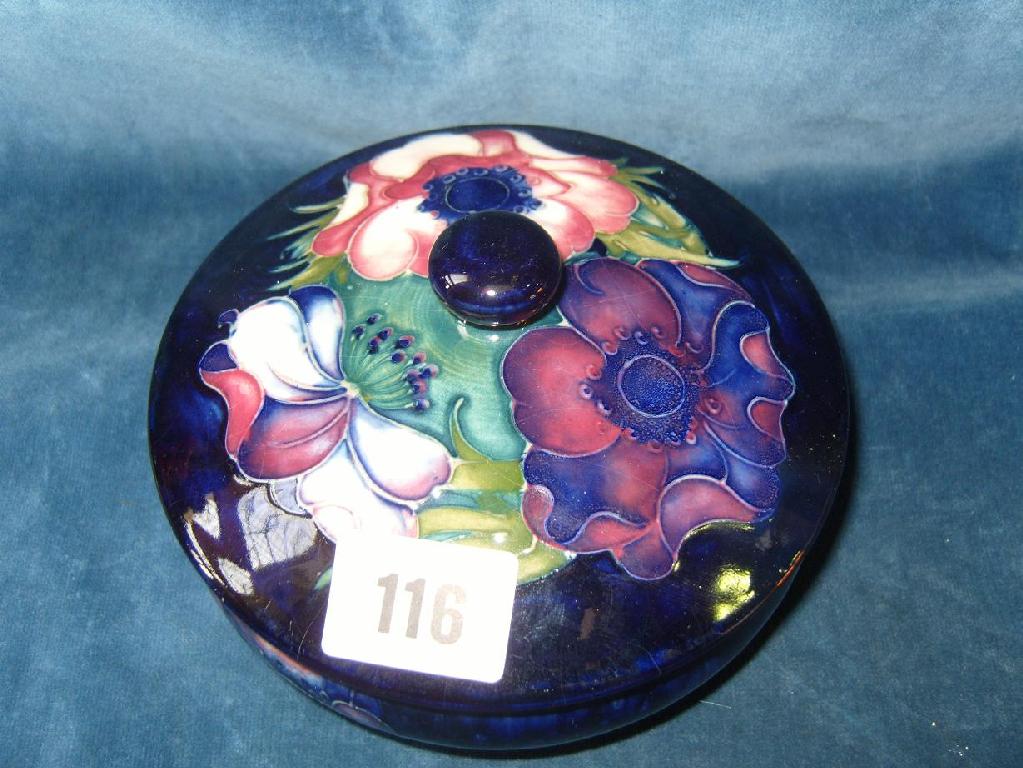 Appraisal: A Moorcroft blue ground powder bowl and cover with pink