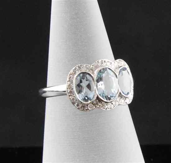 Appraisal: An ct white gold three stone aquamarine and diamond cluster