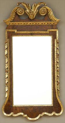 Appraisal: GEORGE II WALNUT AND PARCEL-GILT MIRROR In shaped frame with