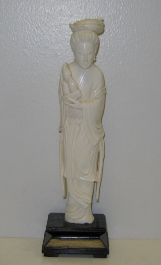 Appraisal: CHINESE CARVED IVORY COURT LADY Standing and holding a basket