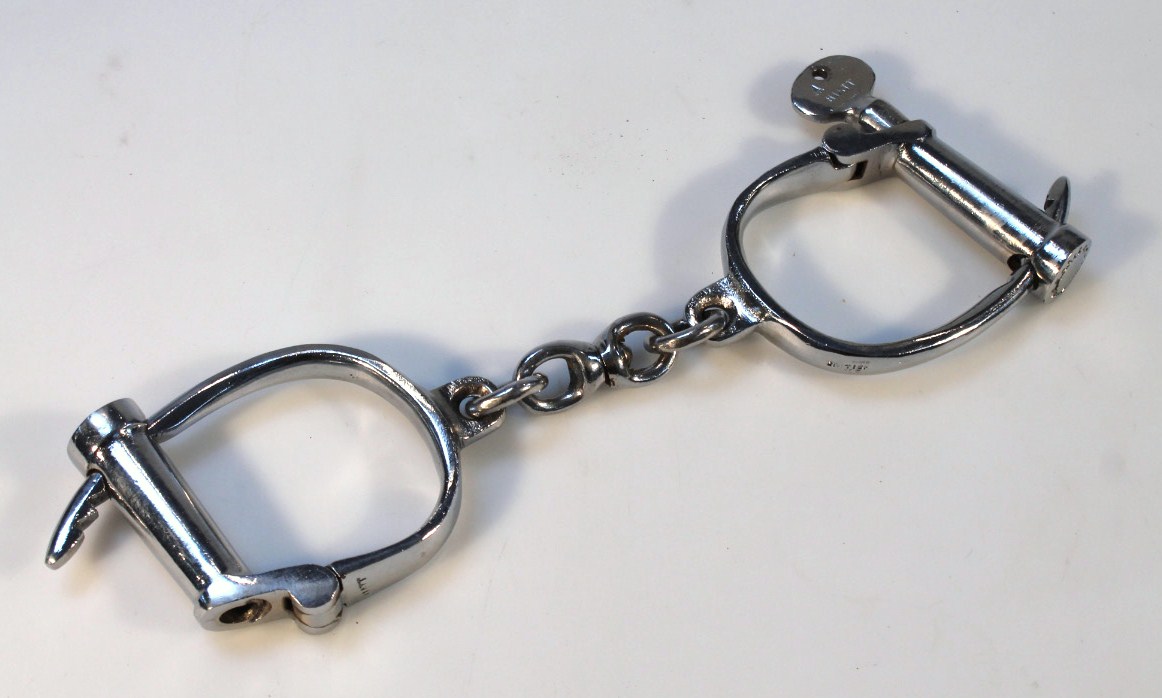 Appraisal: A pair of chrome finish metal Hiatt handcuffs with ring