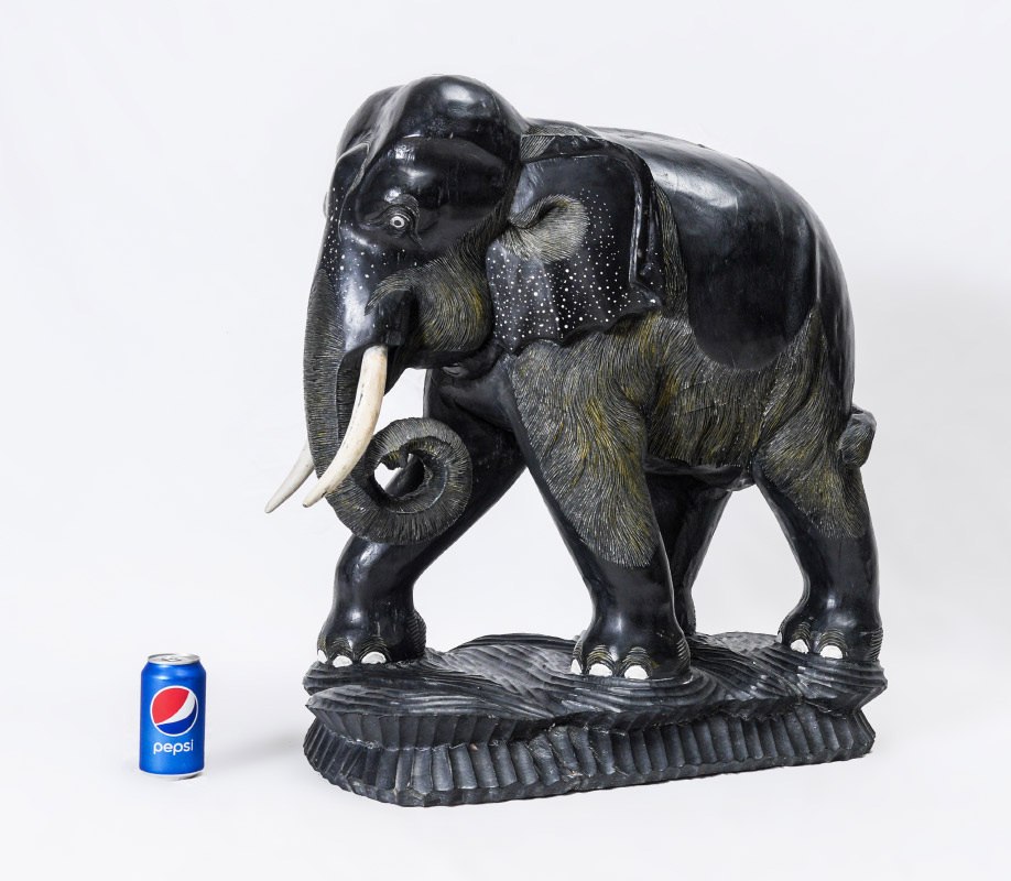 Appraisal: LARGE EBONIZED CARVED ELEPHANT Nicely detailed carving tusks are carved