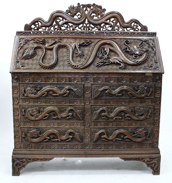 Appraisal: AN ORIENTAL CARVED HARDWOOD BUREAU with pierced dragon cresting overall