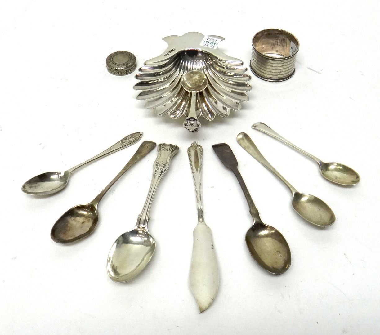 Appraisal: Silver comprising a butter shell raised on three feet Sheffield