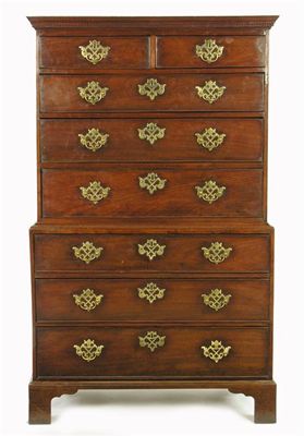 Appraisal: A walnut chest on chest with a dentil cornice above