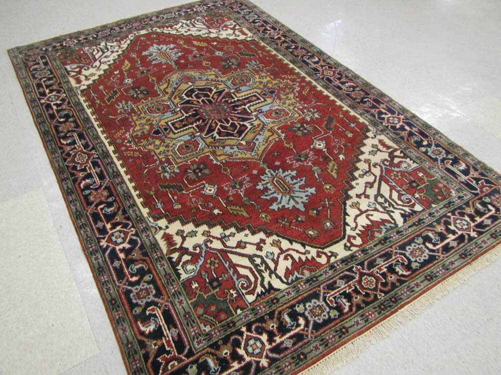 Appraisal: HAND KNOTTED ORIENTAL CARPET Persian Serapi design central geometric medallion