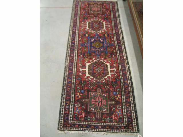 Appraisal: Heriz Persian Handmade Runner geometric medallions trim deep burgundy field