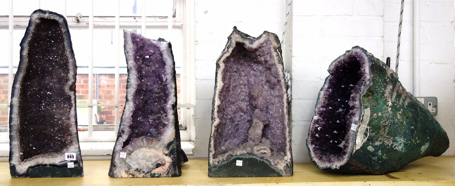 Appraisal: Four amethyst quartz geodes of typical naturalistic form the largest