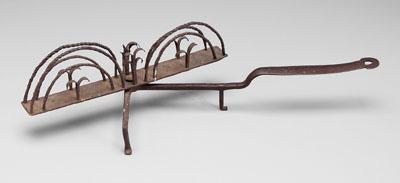 Appraisal: Wrought iron toaster T-shaped frame on three legs spiral-arched receptacles