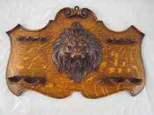 Appraisal: A well carved oak pipe rack with four rests and