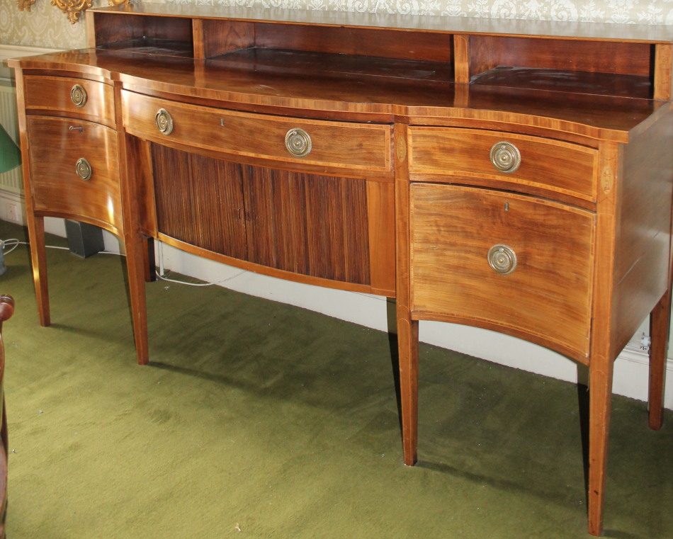 Appraisal: A George III mahogany serpentine fronted sideboard with raised back