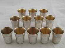 Appraisal: A set of twelve white metal tests grade silver kiddush