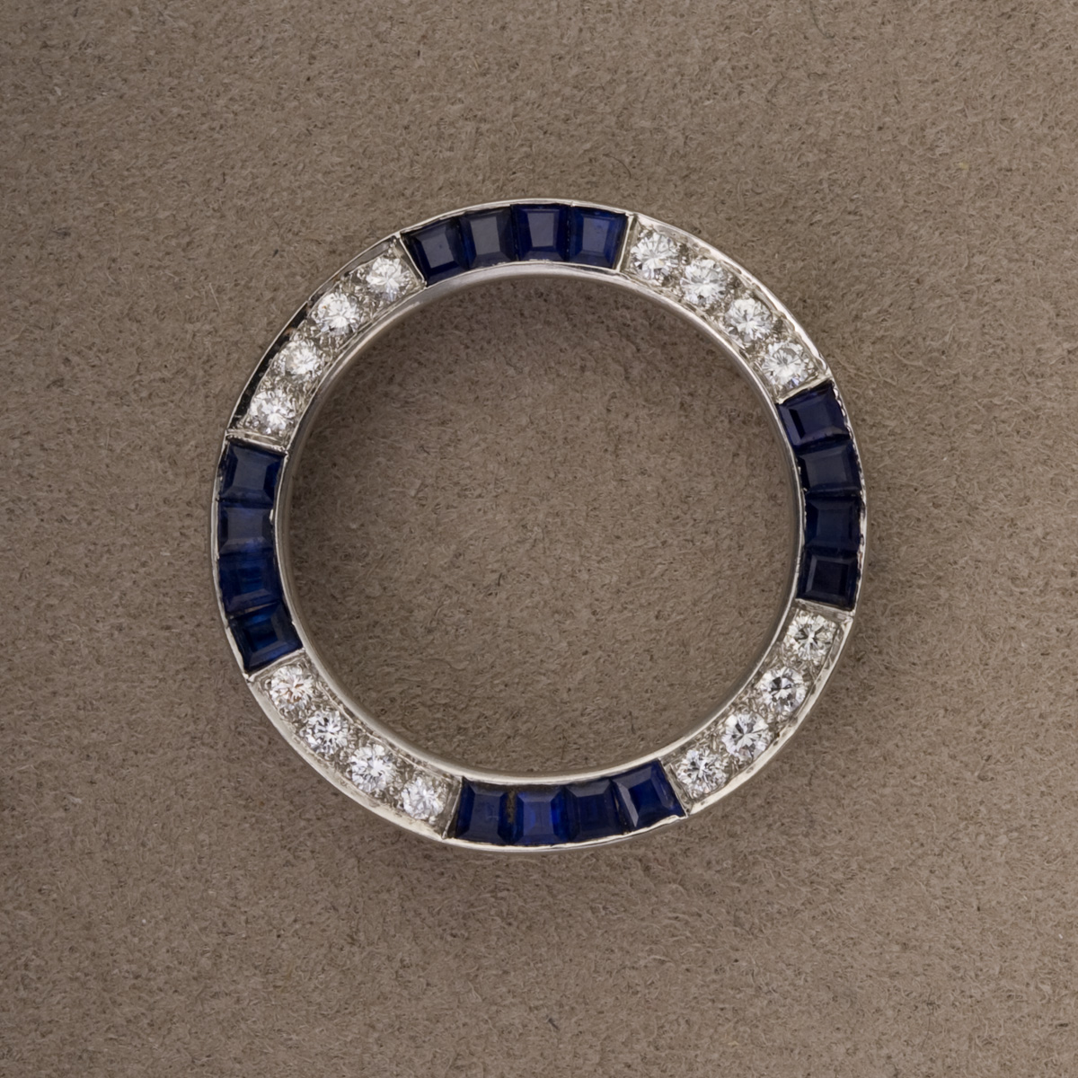 Appraisal: PLATINUM DIAMOND AND SAPPHIRE CIRCLE PIN Set with round brilliant