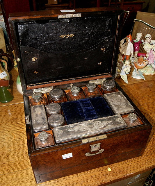 Appraisal: Victorian walnut travelling boxwith fitted interior with numerous glass bottles