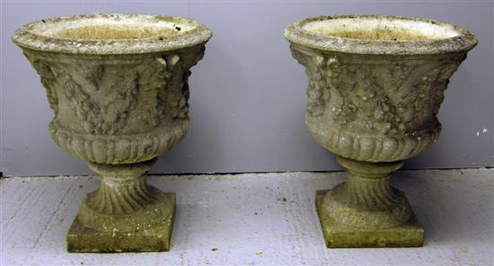 Appraisal: Pair of th century composite garden urns decorated with festoons