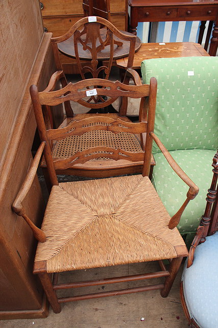 Appraisal: AN OAK PIERCED LADDERBACK OPEN ARMCHAIR with rush seat cm