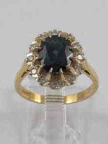 Appraisal: A diamond and sapphire cluster ring set in ct gold