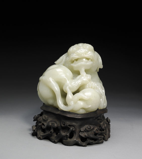 Appraisal: CARVED WHITE JADE LION Beautifully executed Chinese Qianlong-style carved white