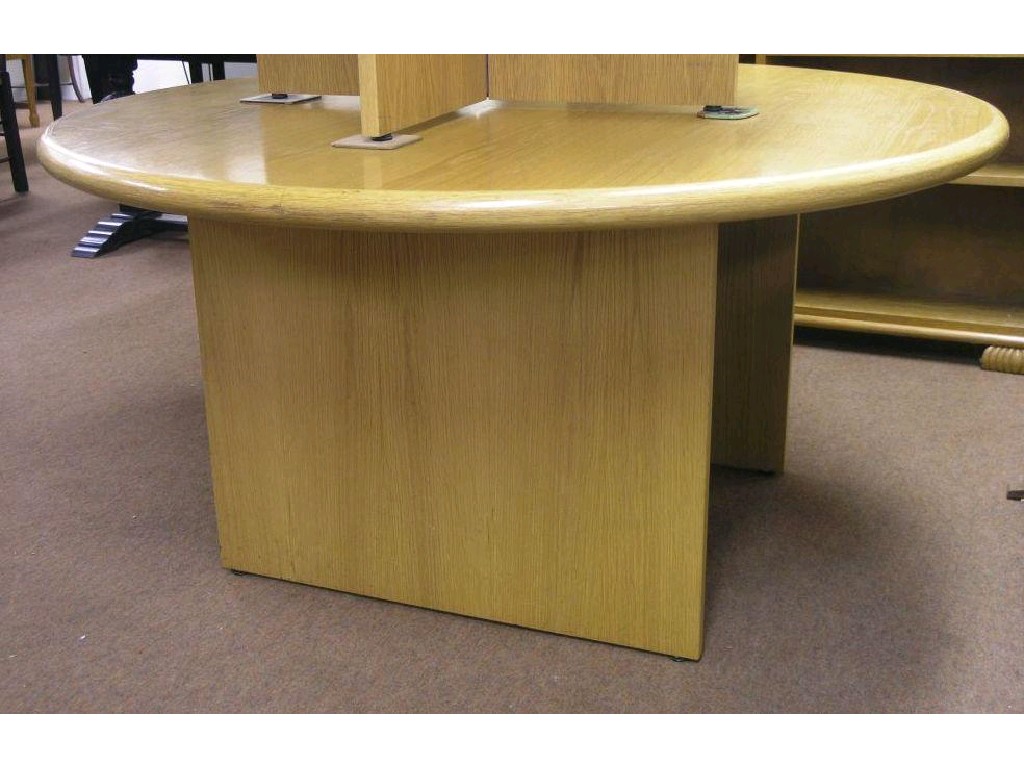 Appraisal: A modern circular light oak table on boarded light oak