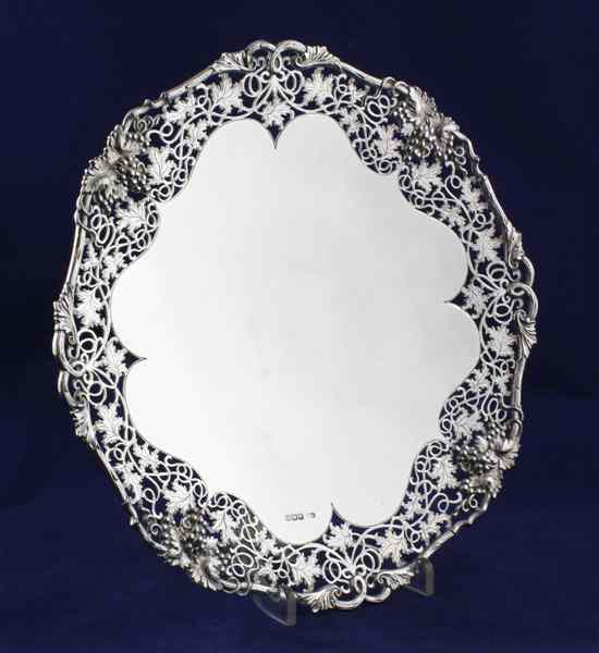 Appraisal: A 's silver cake stand with pierced fruiting vine border