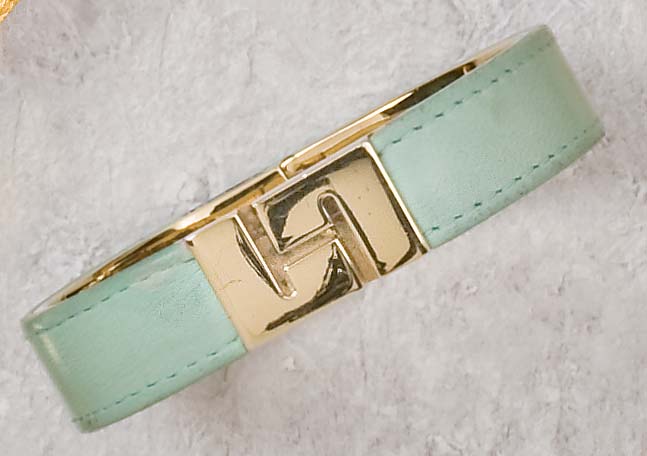 Appraisal: LEATHER BRACELET Hinged bangle with green leather design with signature