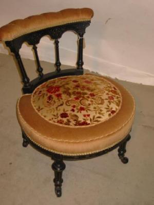 Appraisal: A VICTORIAN EBONISED NURSING CHAIR in floral patterned fawn covering