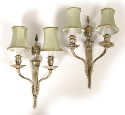 Appraisal: A pair of silvered brass twin branch wall lights in