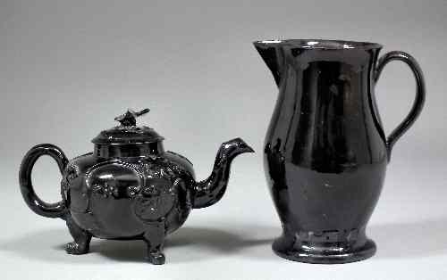 Appraisal: An th Century English black glazed Jackfield globular teapot and