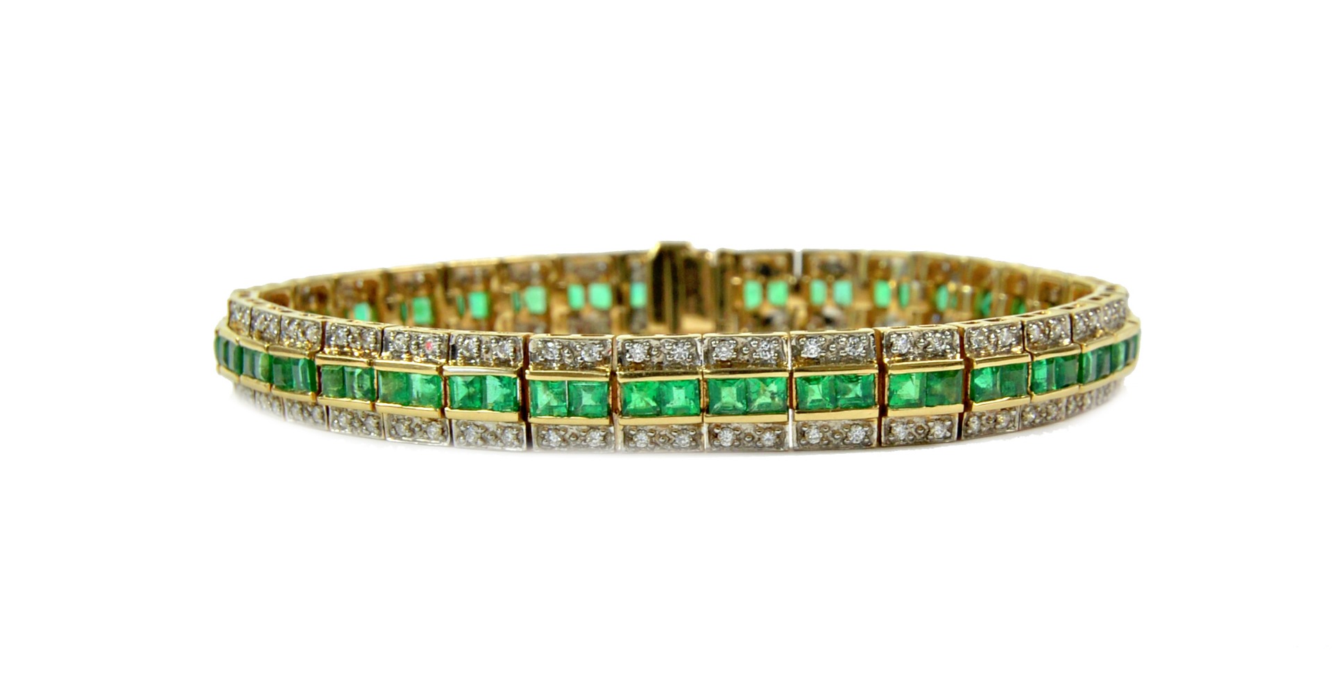 Appraisal: A gold emerald and diamond line bracelet with rectangular articulated