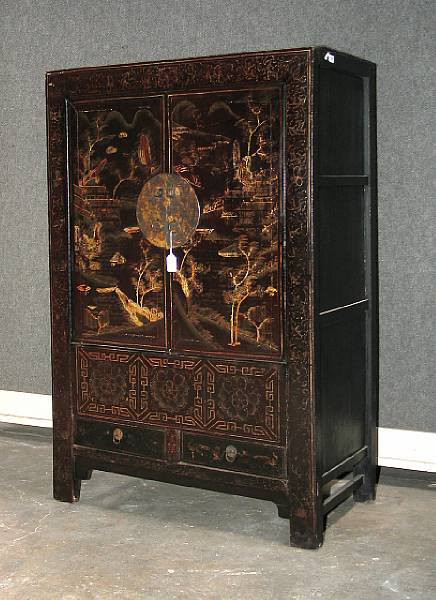 Appraisal: A black and gilt lacquered wood two-door wardrobe chest Its