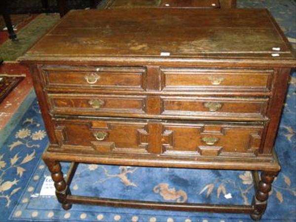 Appraisal: A Carolean style geometric mitred oak chest on stand