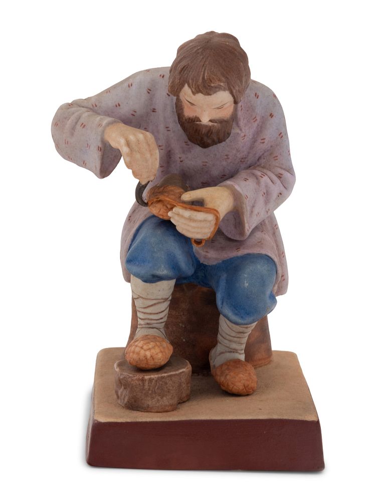 Appraisal: A Russian Porcelain Figure of a Bast Shoe Maker A