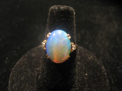 Appraisal: karat yellow gold white opal and diamond ring Colorful white