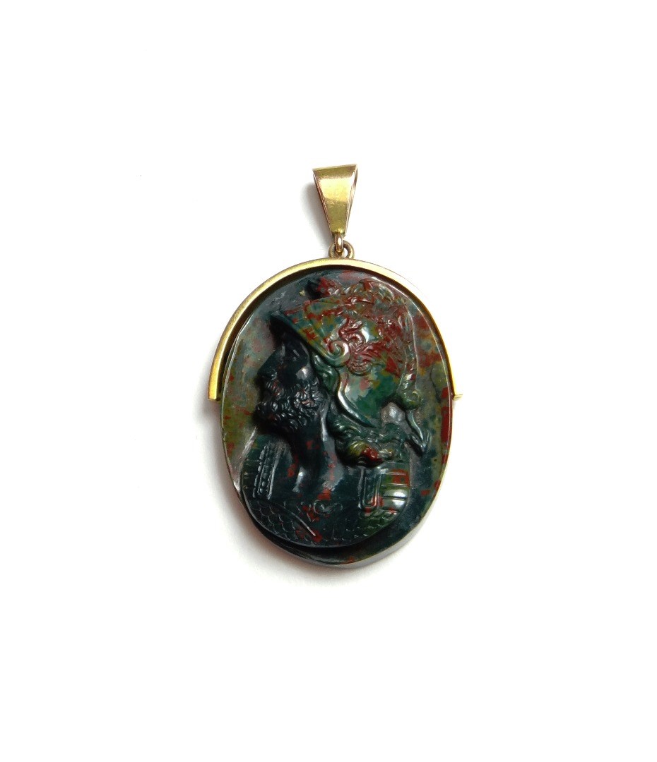 Appraisal: A bloodstone carved cameo oval pendant designed as the bearded