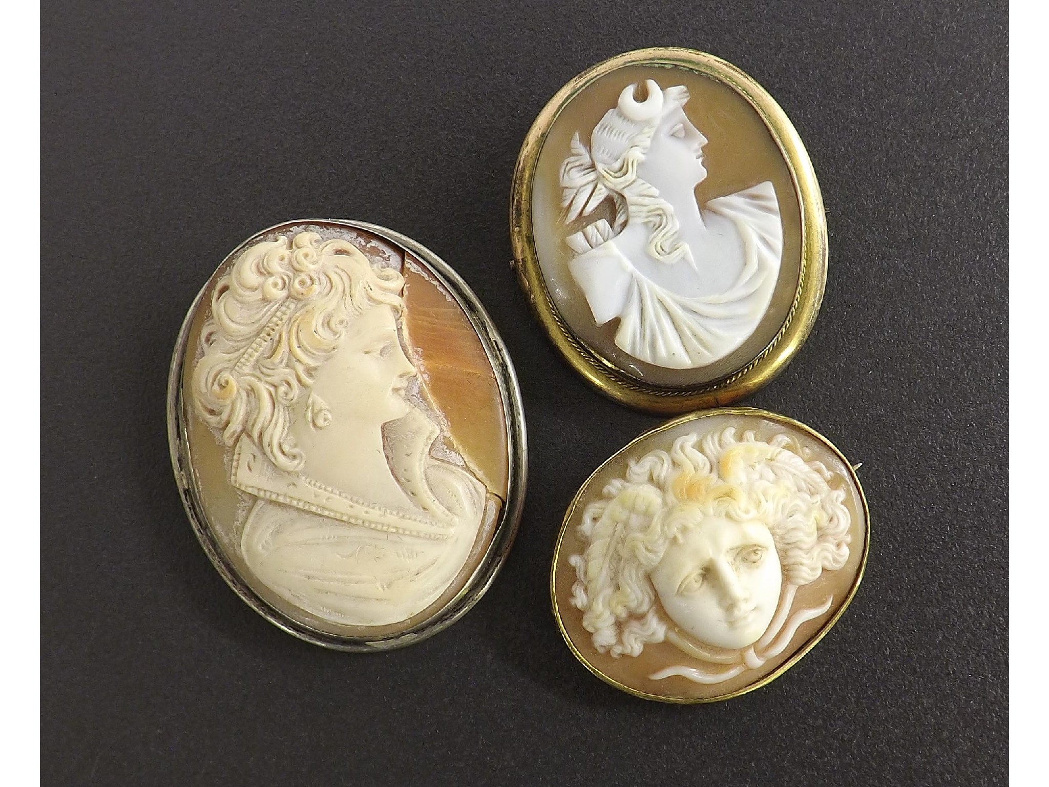 Appraisal: Three carved shell cameo brooches to include oval cameo carved