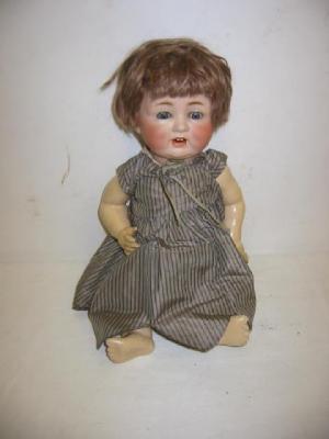 Appraisal: A German bisque head character doll with blue lashed sleeping