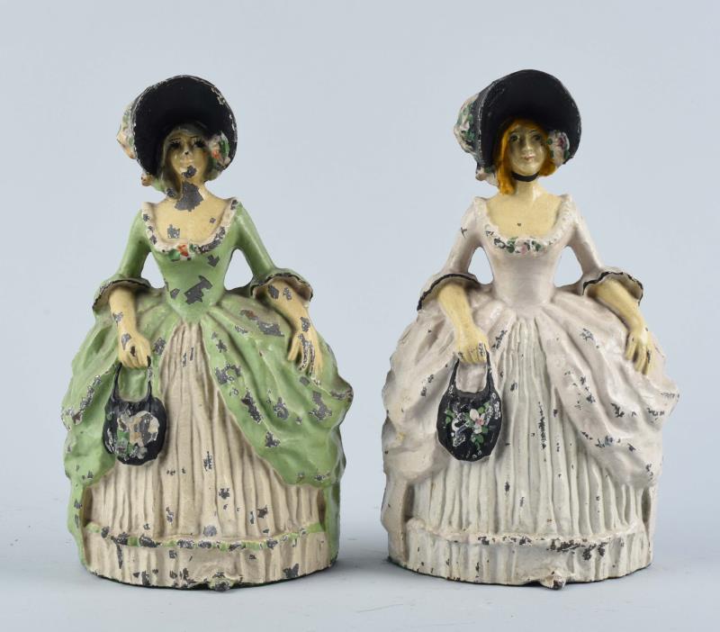 Appraisal: Cast Iron Colonial Women Doorstops Signed LVL Pat Pend Candlestick